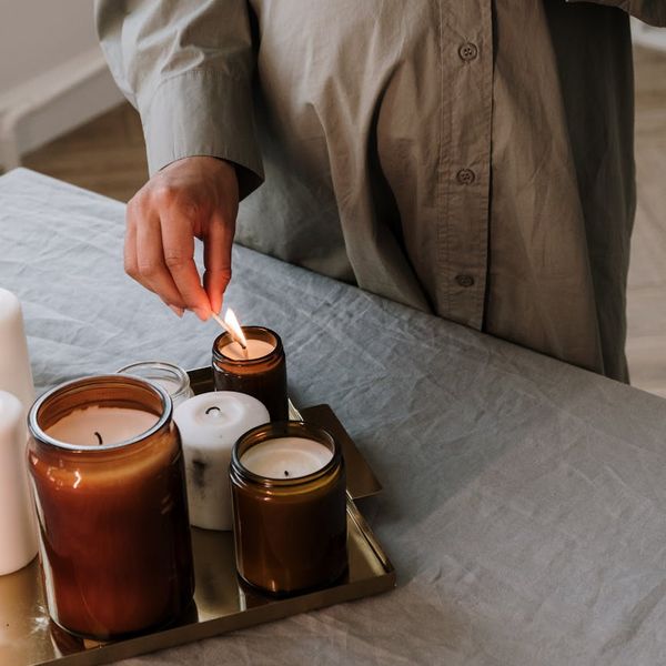 Person meditating peacefully in a serene, minimalist setting with soft lighting.